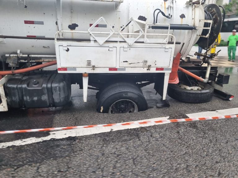 Caminhão fica preso, após buraco se abrir, em avenida de Santos