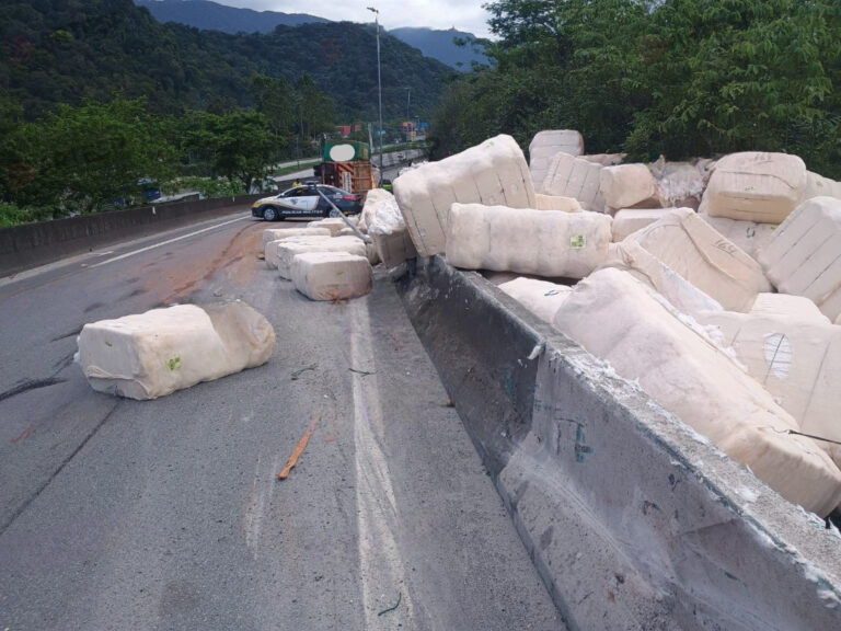 Carreta tomba e carga de plumas de algodão é derramada em rodovia de São Vicente