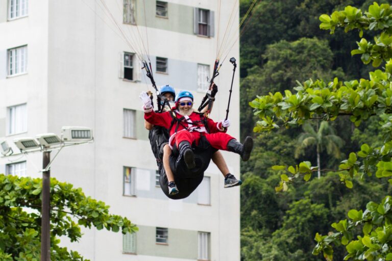 Papai Noel salta de parapente em São Vicente durante programação especial de Natal