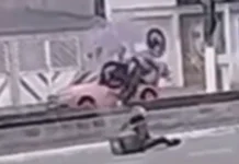 Motoboy tenta empinar veículo, mas perde o controle e moto cai dentro de canal; VÍDEO